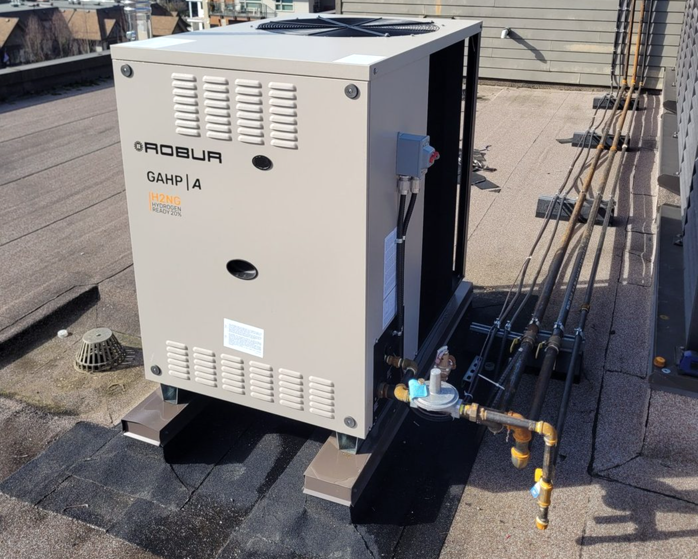 A BES engineer commissioning a gas-fired heat pump on site
